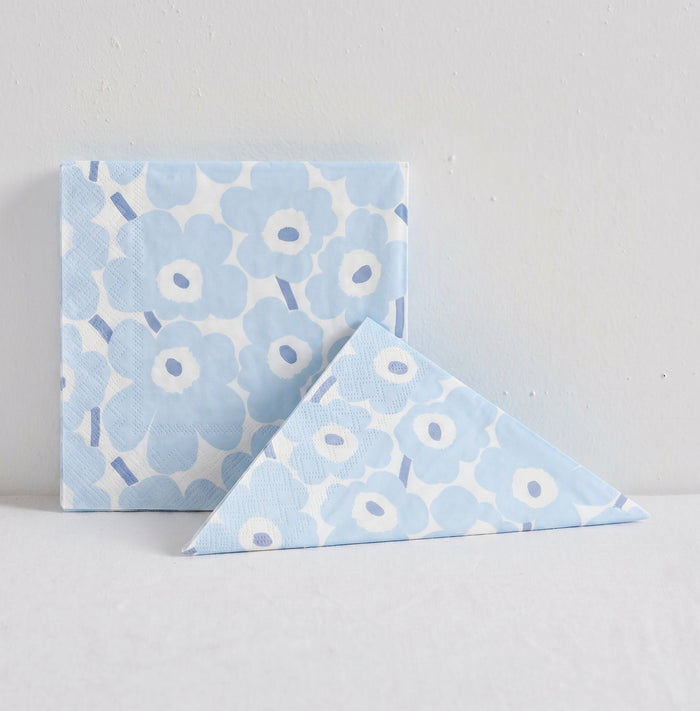 Marimekko Paper Napkin - 20pc - Light Blue with soft blue Unikko poppy pattern, shown folded beside packet
