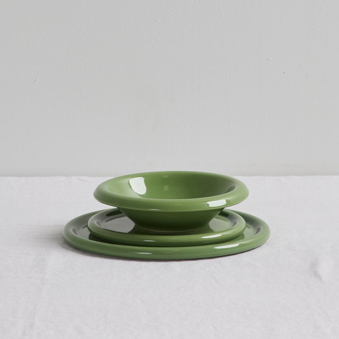 Set of green ceramic bowls on a white background