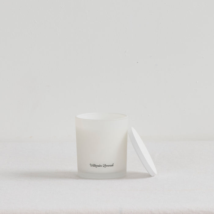 The Scent Collective Candle - Watermelon Lemonade, white home fragrance candle with matching lid on a neutral surface