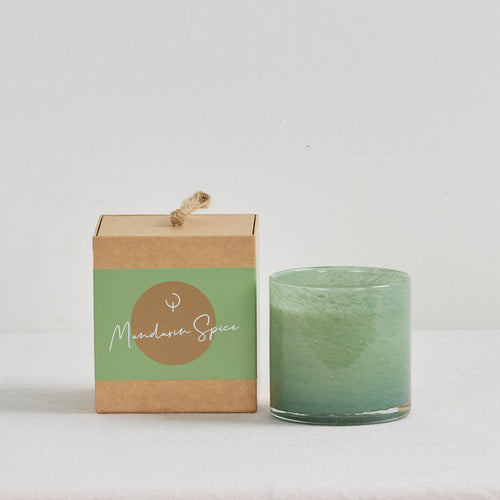 Aurora Candle - Mandarin Spice, soft green glass candle vessel displayed beside its kraft gift box.