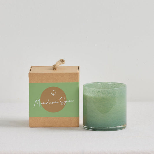 Aurora Candle - Mandarin Spice, soft green glass candle vessel displayed beside its kraft gift box.