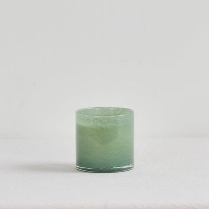 Aurora Candle - Mandarin Spice, luxury home fragrance in a soft green glass vessel with a warm zesty scent.