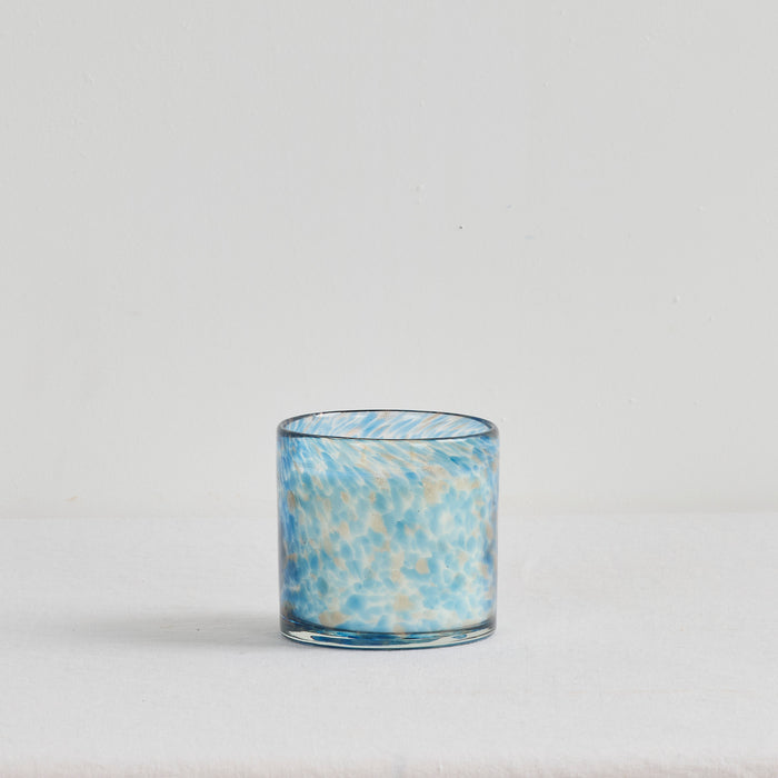 Aurora Candle - Sea Mist in a mottled blue and gold glass vessel, coastal home fragrance candle.