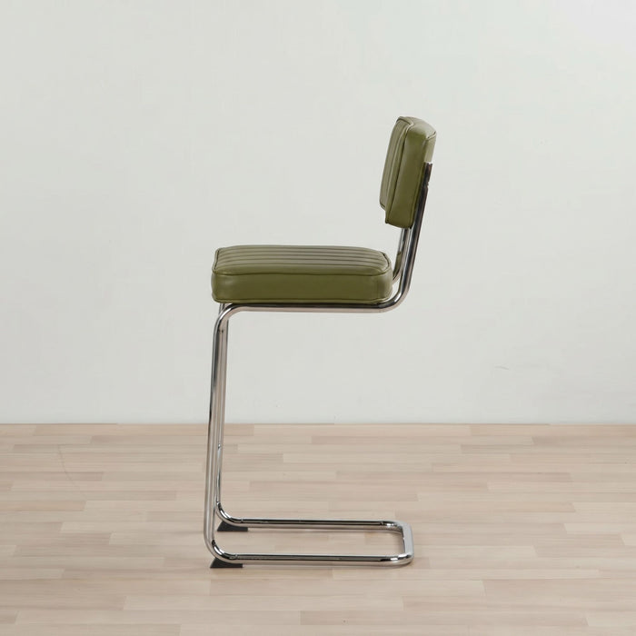Green bar stool with a metal frame on a wooden floor.