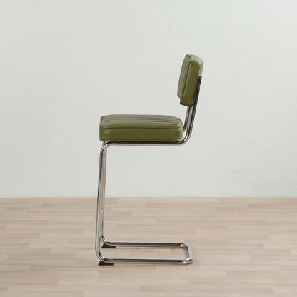 Green bar stool with a metal frame on a wooden floor.