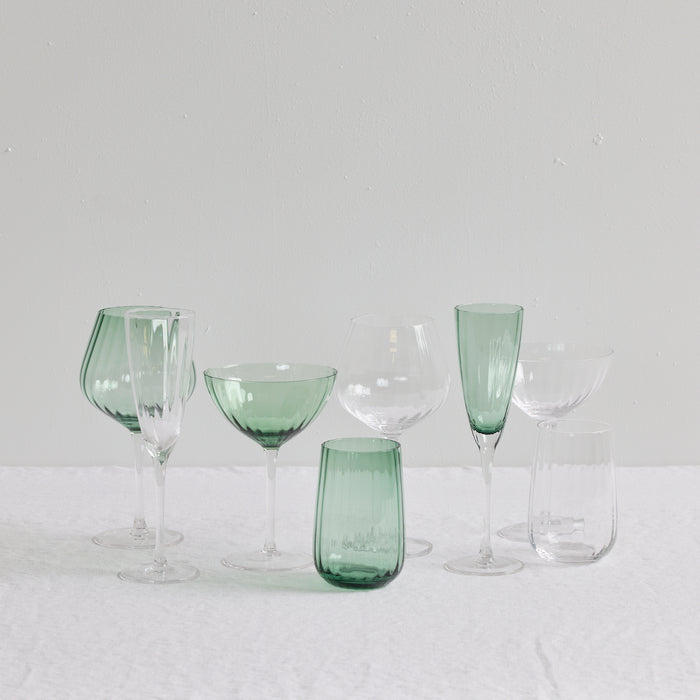 Bravo Coupe Glass Set - 2pc - Green, soft green coupes with clear stems styled among coordinating glassware.