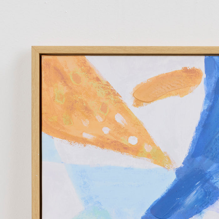 Framed abstract painting with gold, blue, and white colors on a light background