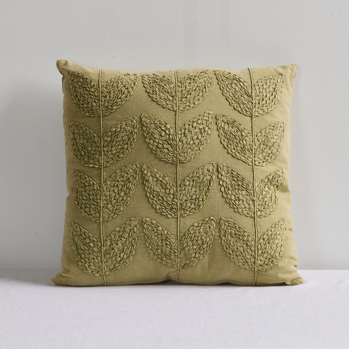 An olive green decorative throw pillow with a textured, raised leaf pattern, set against a plain light gray background.