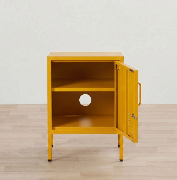 Yellow metal cabinet with open door on a wooden floor against a white wall
