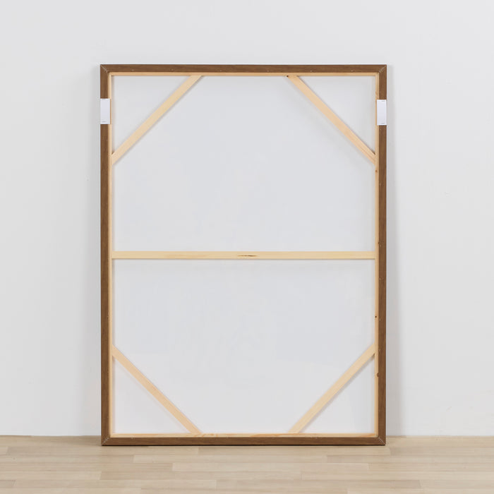 Wooden picture frame with geometric design on a white wall