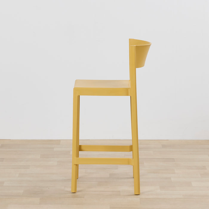 Kip Counter Stool - Yellow side view with mustard finish, square seat, open backrest and footrest on timber flooring