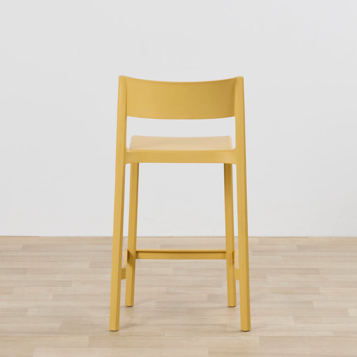 Kip Counter Stool - Yellow with mustard finish, square seat, open backrest and footrest on timber flooring