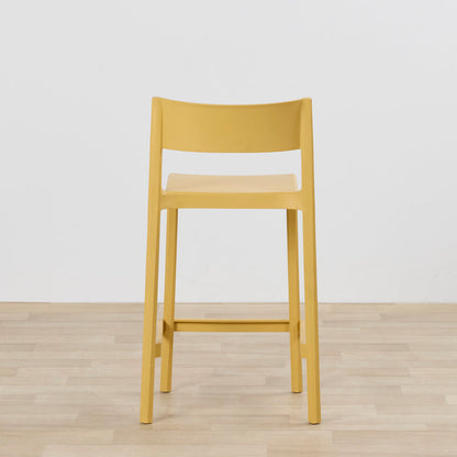 Kip Counter Stool - Yellow with mustard finish, square seat, open backrest and footrest on timber flooring