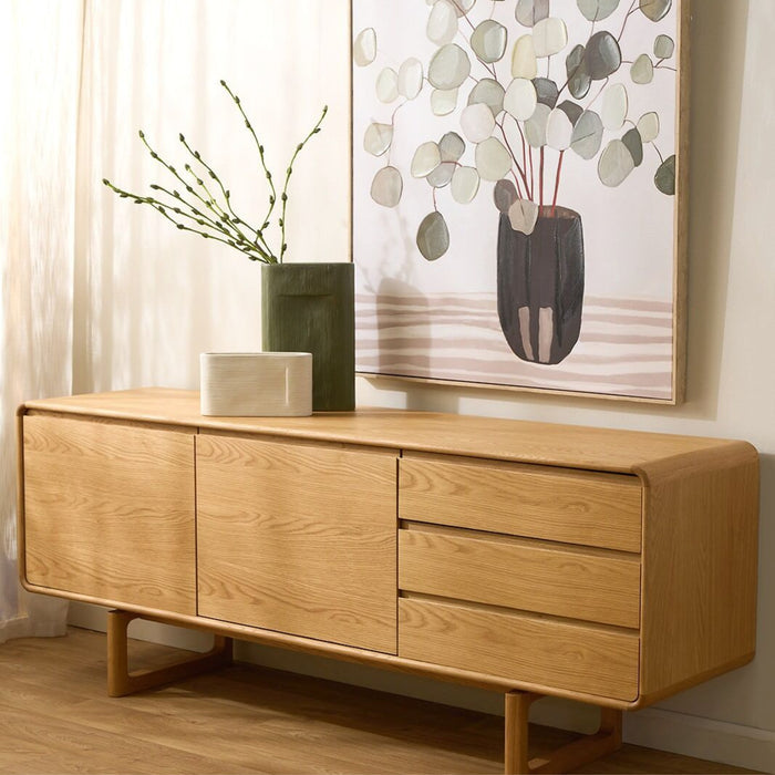 Linea Tall Vase - Green, tall green ceramic vase with budding branches on a timber sideboard beneath botanical wall art