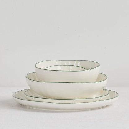 Lotus Side Plate - White/Green, white side plate with a fine green rim, stacked with matching dinnerware