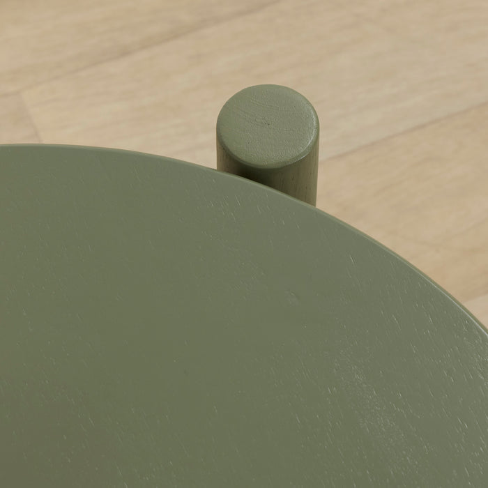 Maeve Dining Chair - Green, close-up of the smooth rounded solid wood backrest and cylindrical support on timber flooring
