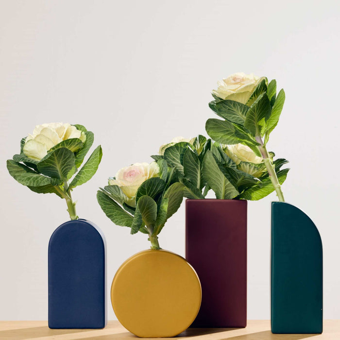 Mono Arch Vase - Green, green ceramic arch vase styled with white flowers among colourful vases