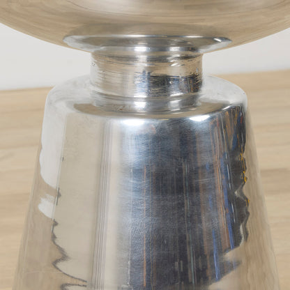 Obelisk Side Table - Chrome, close-up of polished chrome sculptural pedestal base beneath a round tabletop