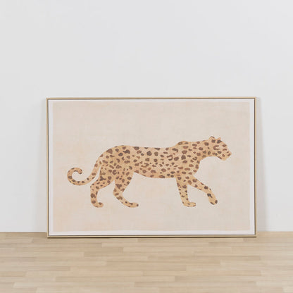 On The Prowl Framed Artwork featuring a spotted leopard silhouette in warm neutral tones, leaning against a white wall