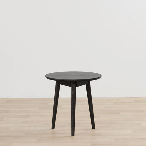 Orlando Small Side Table - Black round black side table with tapered legs on a light timber floor