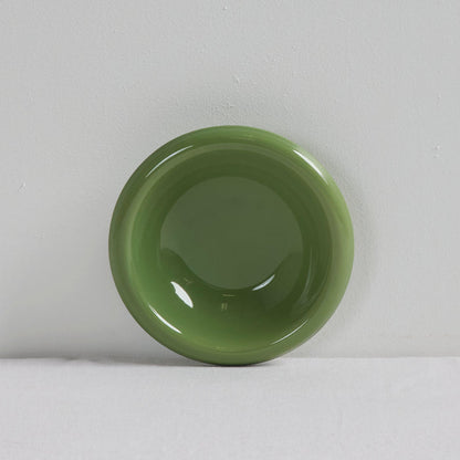 Green ceramic bowl on a white background