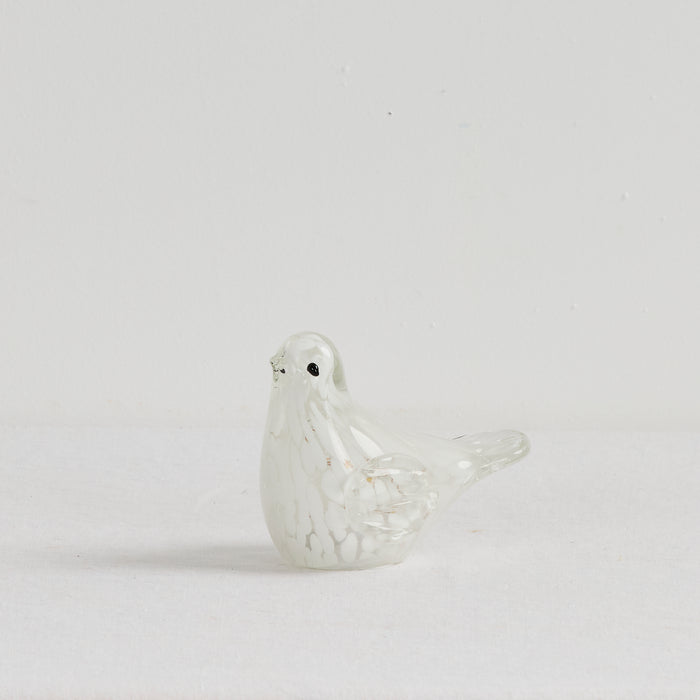 White ceramic dove on a light gray background