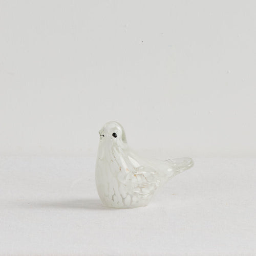 White ceramic dove on a light gray background