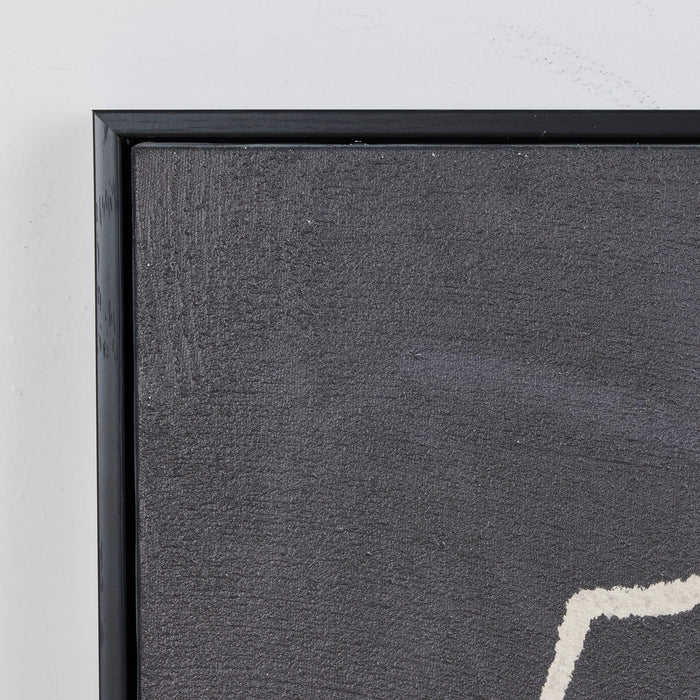 Close-up of a textured gray wall with a black frame.