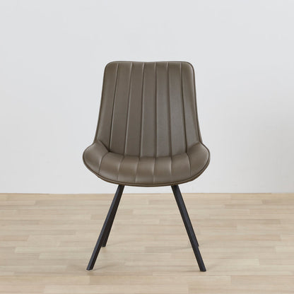 Brown chair with black legs on a wooden floor and light gray background