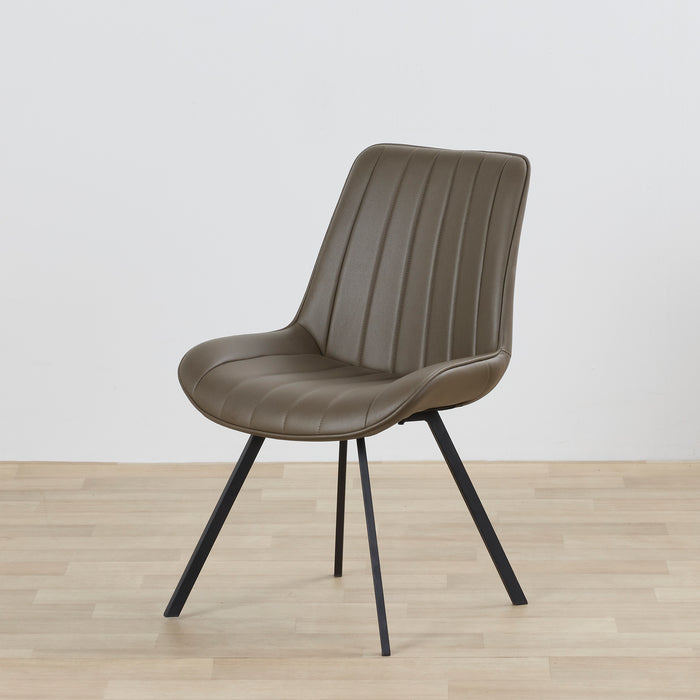 Brown chair with black legs on a wooden floor and light gray background