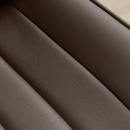 Close-up of a textured leather or faux-leather surface in a warm taupe-brown color, showing stitched diagonal channels.