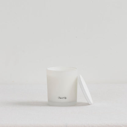 The Scent Collective Candle - Pear and Fig, white home fragrance candle with matching lid on a neutral surface