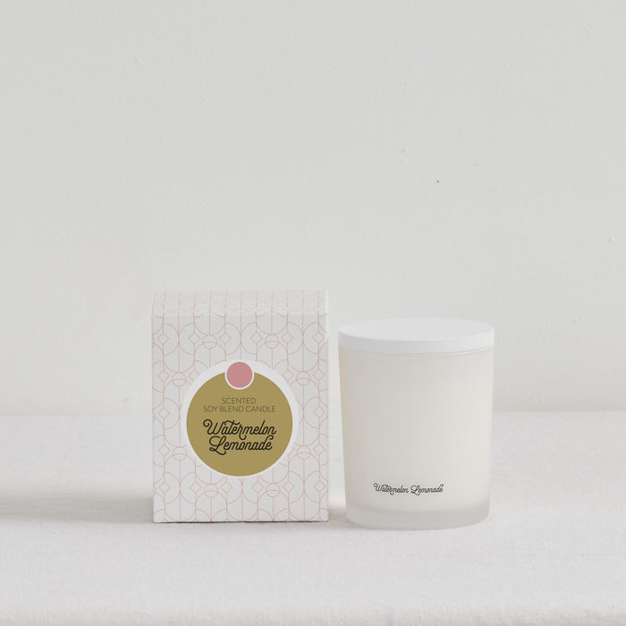 The Scent Collective Candle - Watermelon Lemonade, white home fragrance candle beside patterned gift box on a neutral surface
