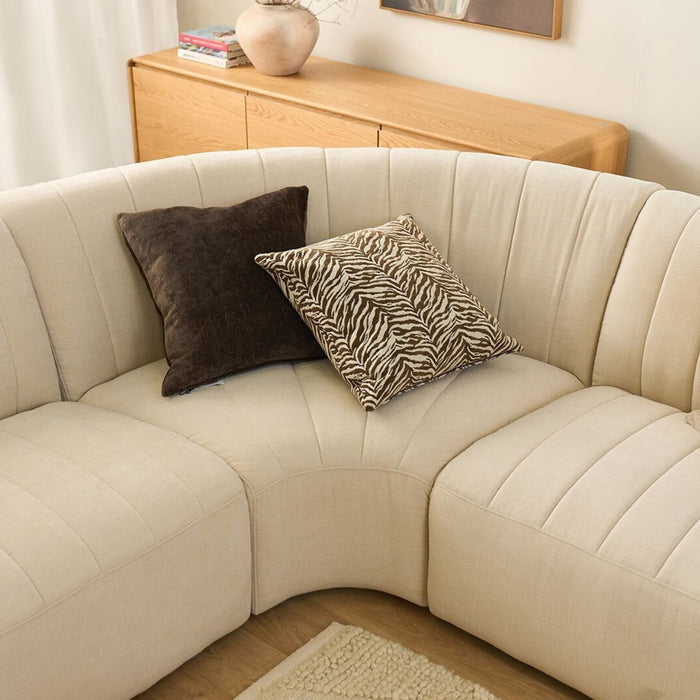 Tiger Cushion - 50x50cm - Chocolate/White, tiger-patterned cushion styled on a cream curved sectional sofa.