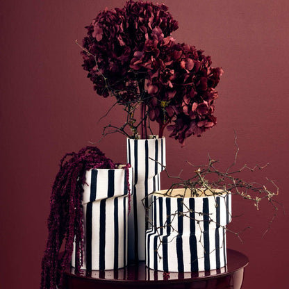 Twist Striped Medium Vase - White/Black, sculptural striped vase styled with dried burgundy flowers and matching vases.