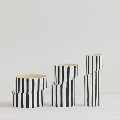 Twist Striped Tall Vase - White/Black, tall sculptural ceramic vase with hand-painted black vertical stripes, shown with matching vases.