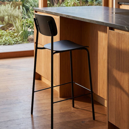 Vincent Counter Stool - Black with streamlined seat and backrest on slender black metal legs and footrest.