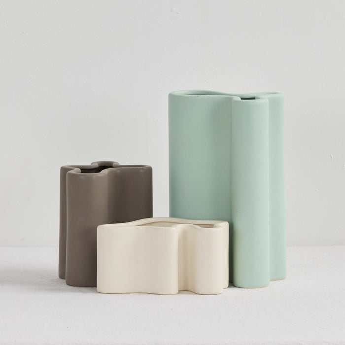 Wave Medium Vase - Charcoal, matte sculptural vase displayed with coordinating sage and cream Wave vases