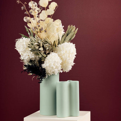 Wave Tall Vase - Sage, softly curved tall sage green vase styled with dried flowers beside a matching smaller vase